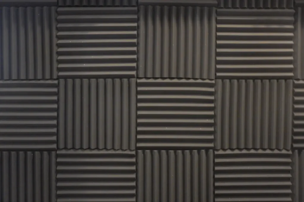 Close-up of textured carpet tiles arranged in a grid pattern.
