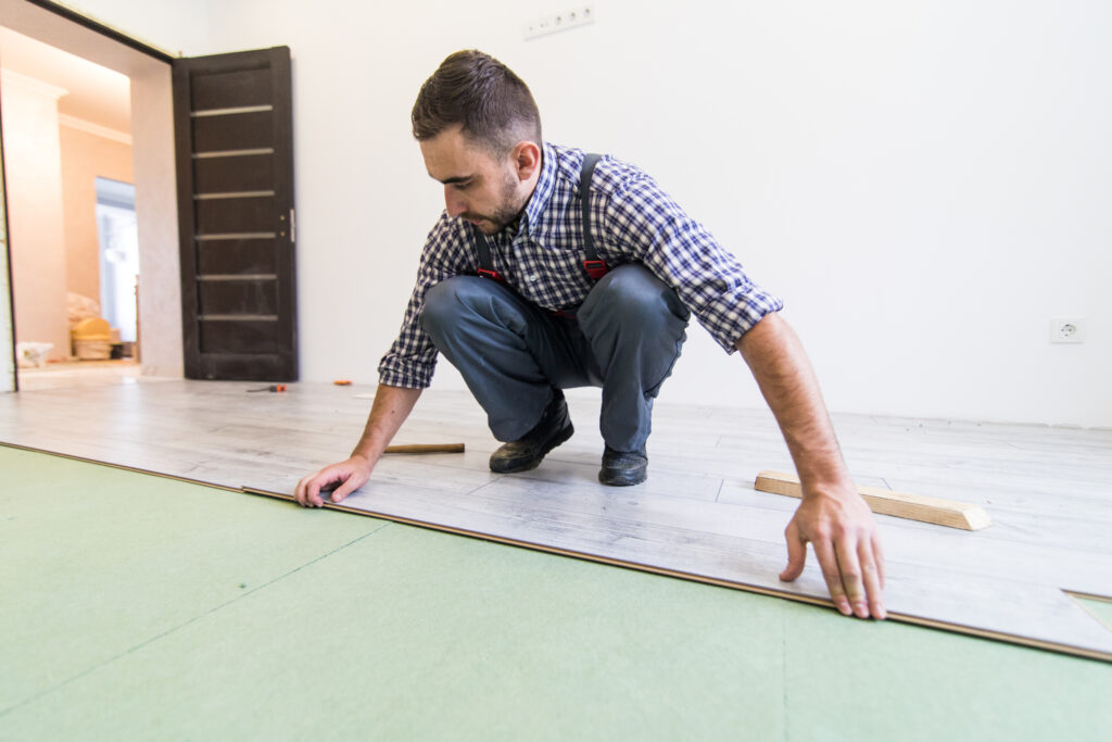 Professional installing SPC flooring planks carefully
