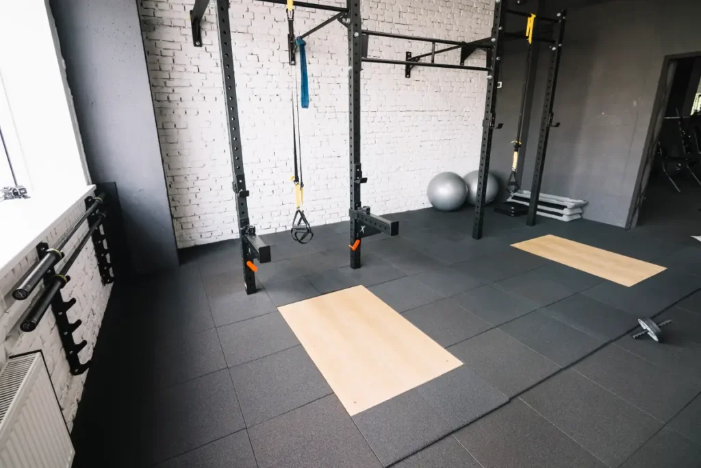 Crossfit gym with rubberized flooring and exercise mats.