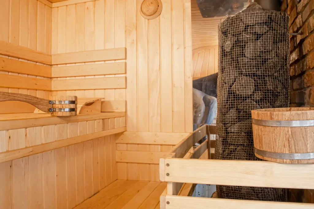 Traditional sauna with wooden benches and a stone heater.