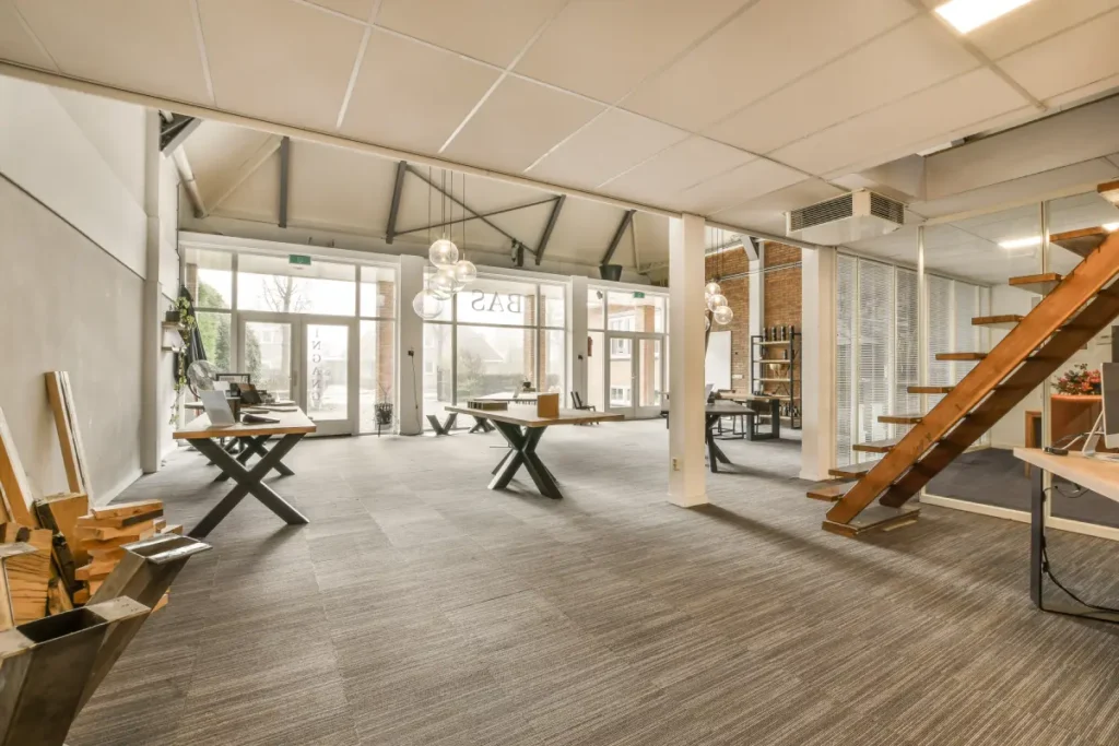 Modern office interior with LVT flooring and staircase.