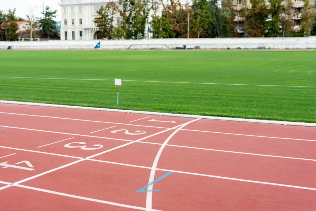 Outdoor running track with clear lane markings and green grass