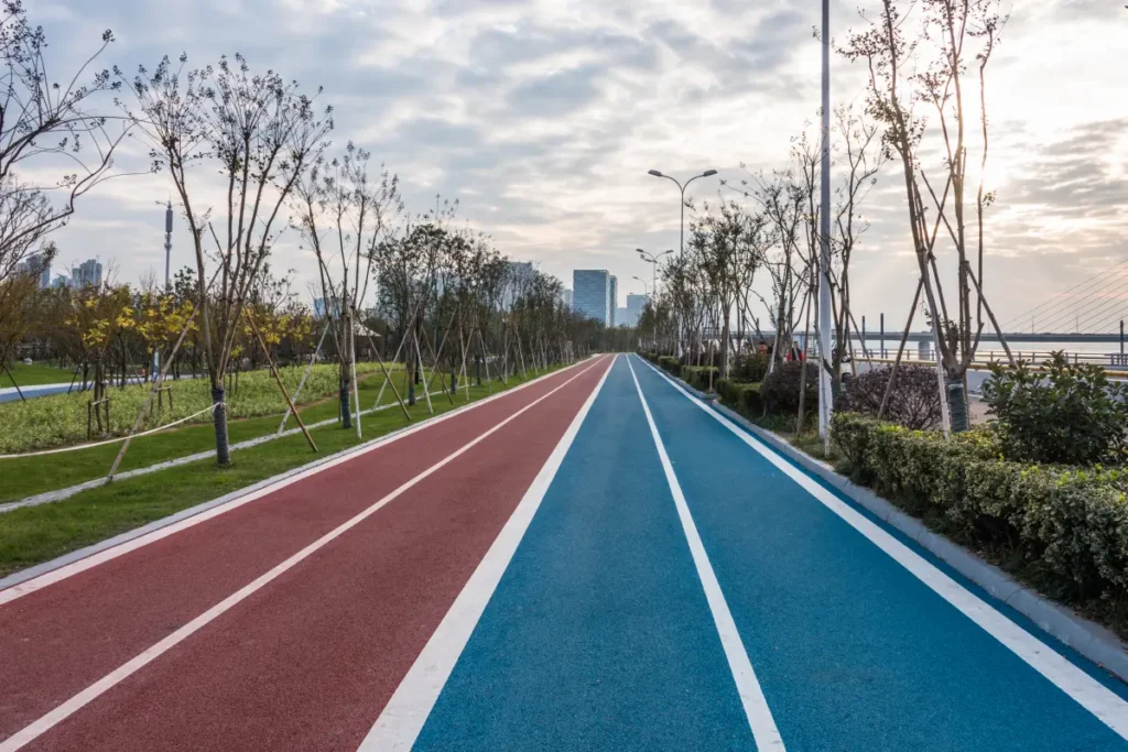 Outdoor running track with red and blue lanes.