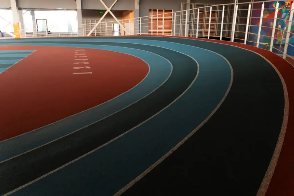 Indoor running track with colorful lanes in a gymnasium