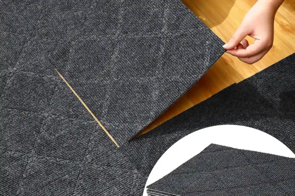 Installer placing a carpet tile on the floor.