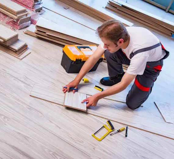 Professional adjusting and cutting SPC planks for floor installation.