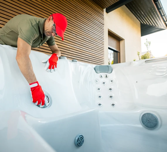 Jacuzzi maintenance in progress with a technician fixing the tub.