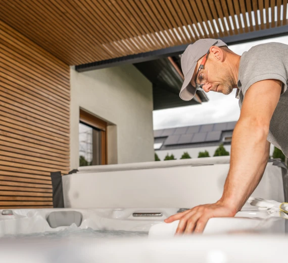 Technician inspecting a Jacuzzi tub during installation.